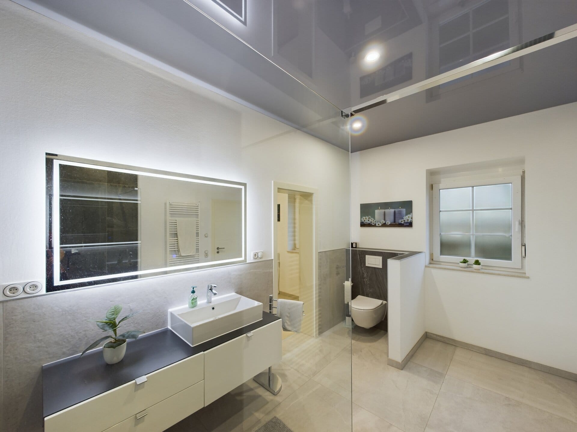 siegelbach-59a-18 Modern bathroom with large mirror, white sink, and window near Ramstein Air Base.