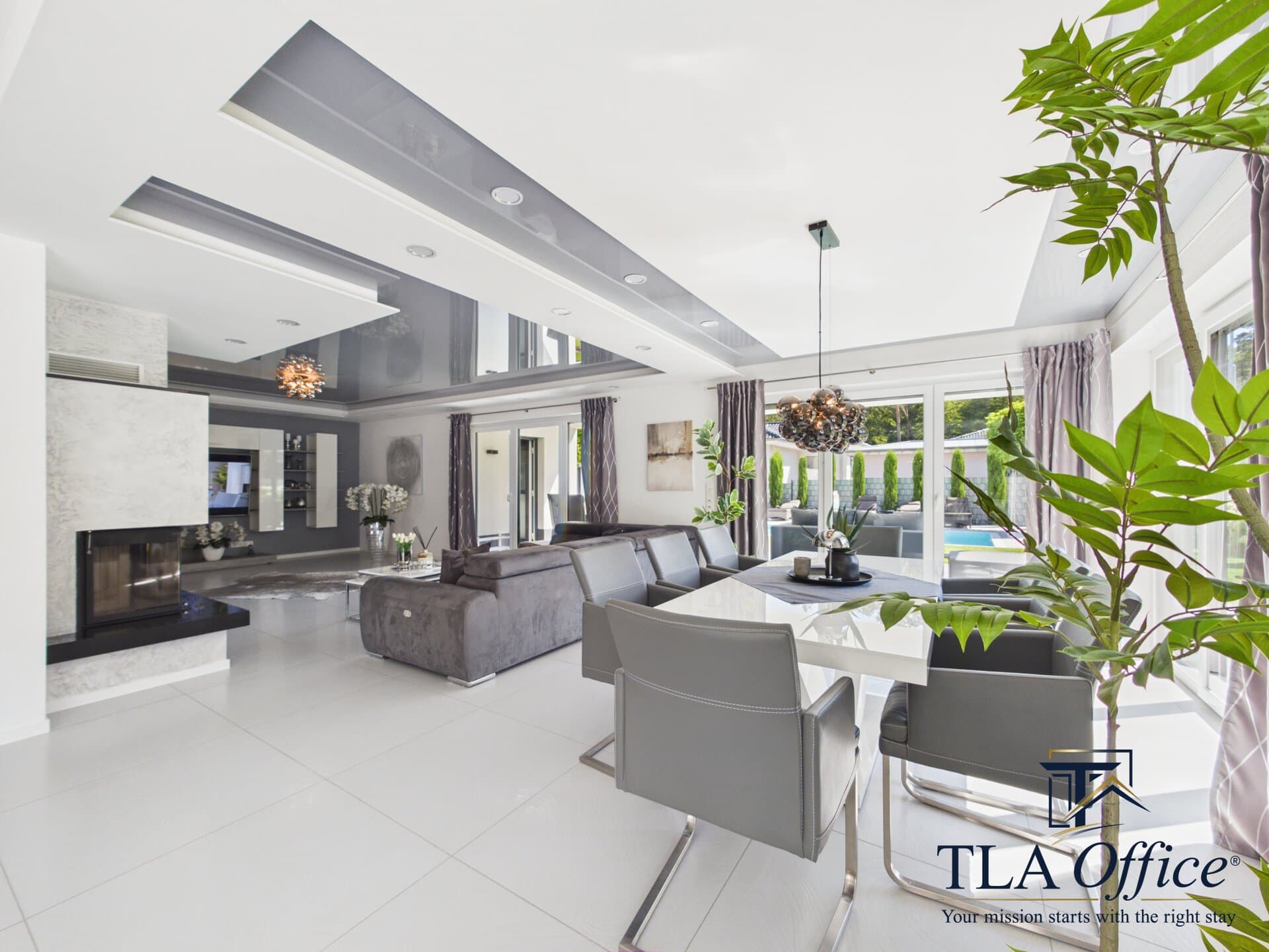 CAM01139G0-PR0080-STILL025 Living and dining room with fireplace and pool view - Luxury TLA Residence Siegelbach