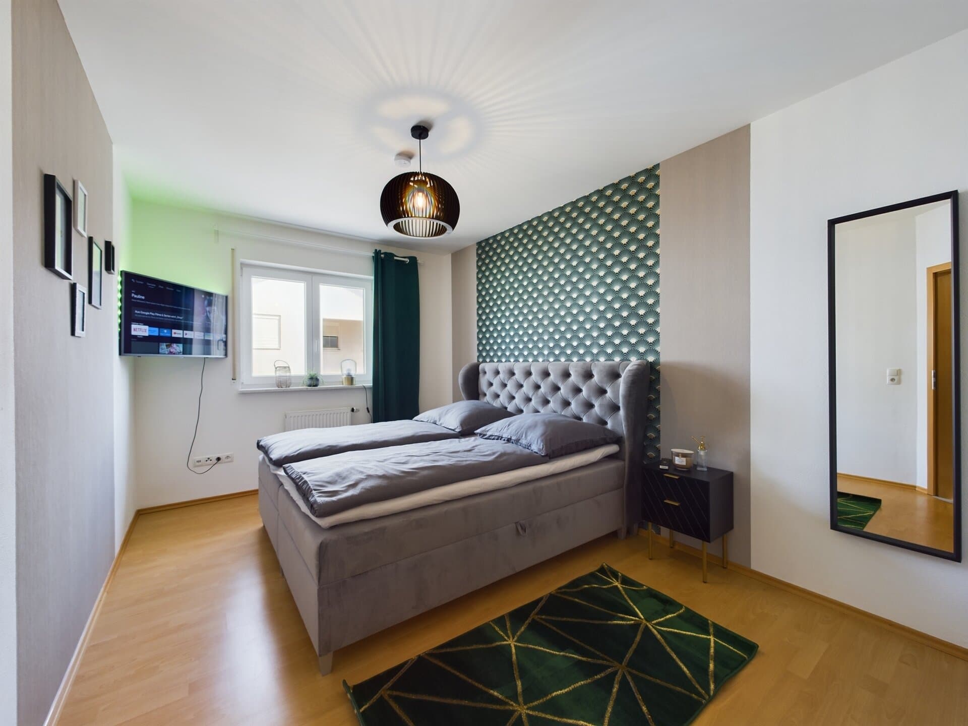 Modern bedroom with stylish decor and a large bed near Ramstein Air Base.
