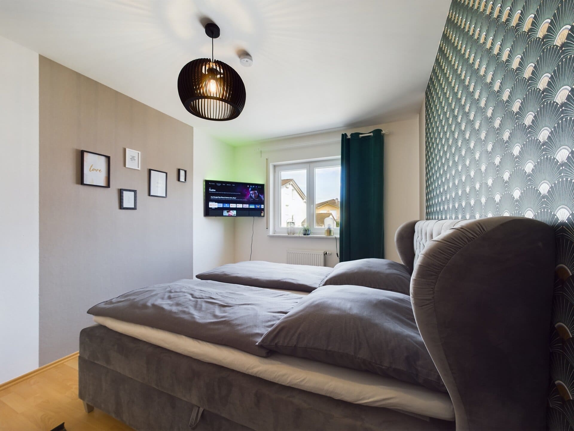 Modern bedroom with stylish decor and large window near Ramstein Air Base.