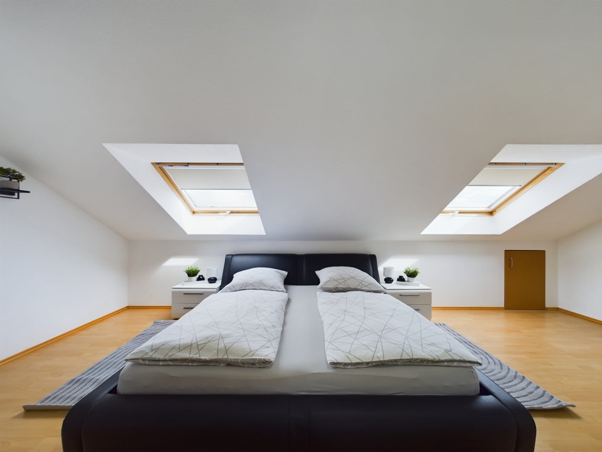 Bright, spacious bedroom with two skylights and modern decor in a TLA house near Ramstein Air Base.