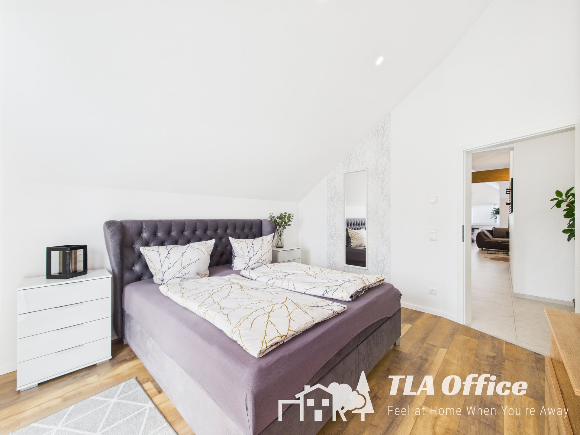 Modern bedroom with purple bed and white decor near Ramstein Air Base.